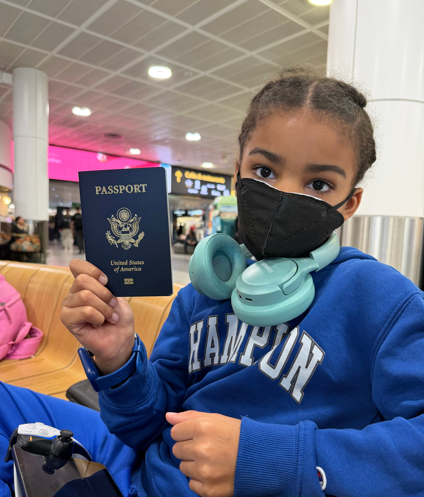 Amber's son holding a U.S. passport at the airport