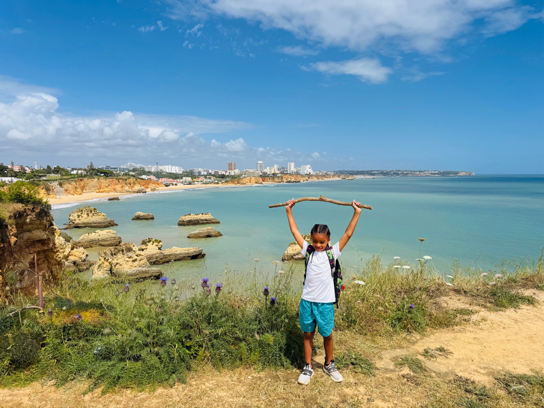 Amber's daughter on a clifftop overlooking the Algarve coast
