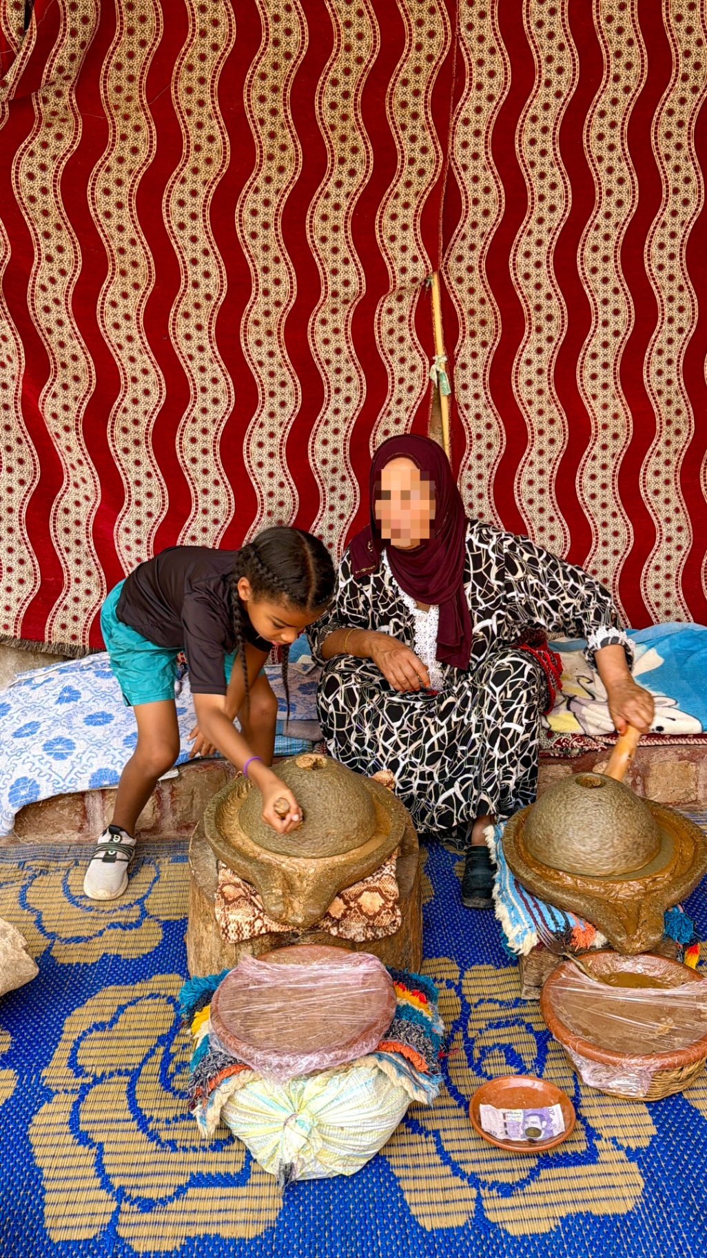 Amber and her son learning traditional pottery making in Morocco