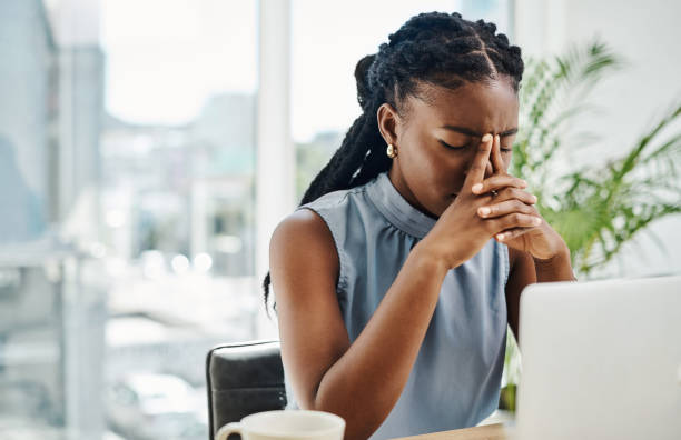 Woman exhausted at her corporate desk late at night